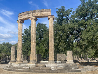 Olympia, Greece - July 4, 2024: Birthplace of the Olympic Games. Philippeion ruin backed by green trees under blue sky