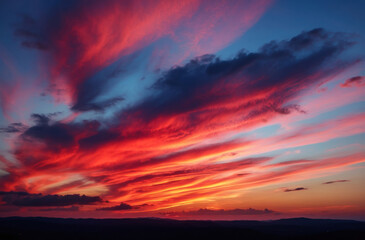 Fototapeta premium Bright clouds at sunset show rich hues in the background, creating an amazing sight.