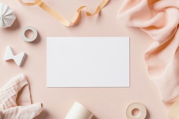 Obraz premium Blank card mockup surrounded by pastel pink fabric, ribbon, and stationery.