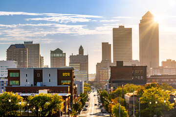 Des Moines, Iowa skyline late afternoon along Locust street. Sun rays burst from behind the...