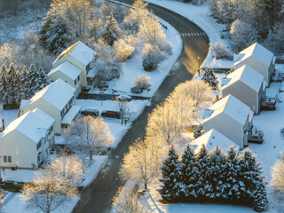 aerial view of residential house after snow storm under sunlight