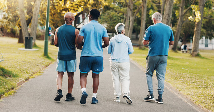 Back, people and outdoor walking for fitness with mobility training, discussion or morning routine. Senior, community and coach with exercise, cardio workout or wellness support of retirement at park