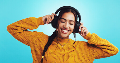 Studio, woman and happy with headphones for music, motivation playlist and sweater for fashion....