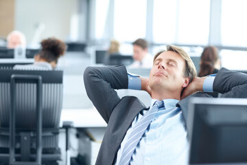 Businessman, relax and stretching with break for productive day, rest or nap at office desk. Happy man, employee or agent leaning with smile for finished, done or completed tasks at agency workplace
