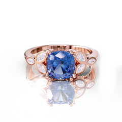 Chic rose gold ring with a vibrant blue sapphire, enhanced by marquise and round diamonds for a stylish, sophisticated appeal.