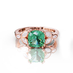 Graceful rose gold ring with a deep green emerald, beautifully set with marquise and round diamonds for a unique, elegant design.