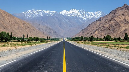 Naklejka premium A serene highway meandering through a mountain pass, with golden autumn trees on both sides and towering rock formations ahead.