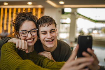 hugged couple take a self portrait or have video call on cellphone