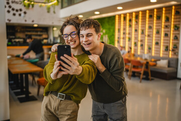 hugged couple take a self portrait or have video call on cellphone