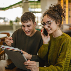 couple learn together and prepare exam on digital tablet at cafe