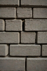 Fototapeta premium Brick Wall Texture: A close-up shot captures the rough texture and intricate patterns of a brick wall, perfect for backgrounds and design elements.