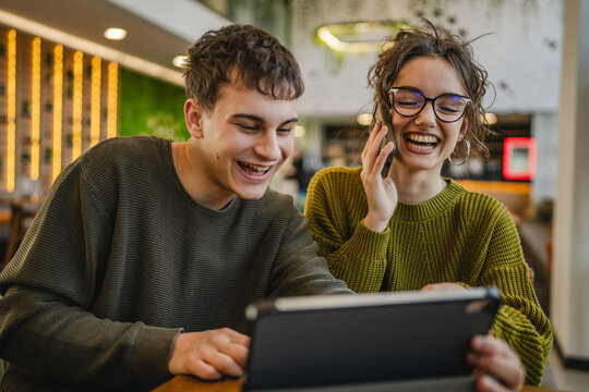 couple learn together and prepare exam on digital tablet at cafe