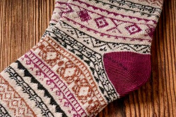A socks displayed on a table. The socks are likely made of knitted textile, showcasing various...