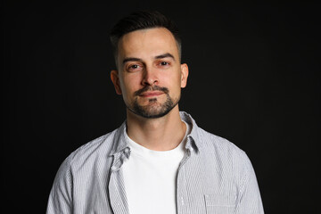 Obraz premium Portrait of handsome middle aged man on black background