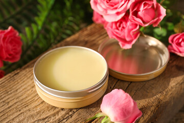 Natural solid perfume and pink roses on wood, closeup