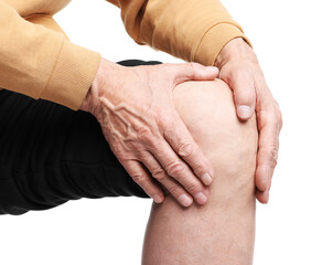 Senior man suffering from knee pain on white background, closeup