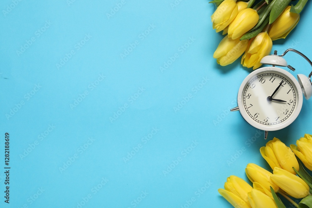 Poster spring time. alarm clock and beautiful tulips on light blue background, flat lay. space for text