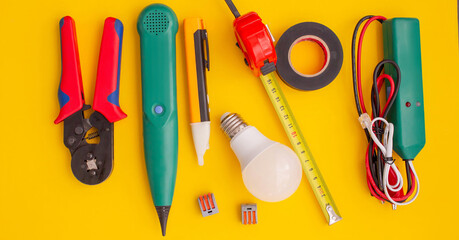 Electrical Tools and Equipment on Yellow Background