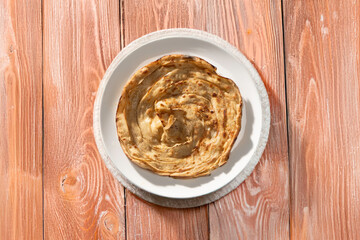 Lachha paratha or chur chur naan on a white plate