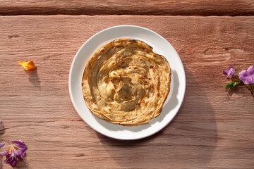 Lachha paratha or chur chur naan on a white plate