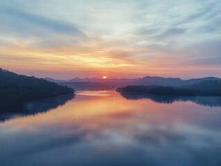 Obraz premium Aerial View of Serene Sermo Lake at Sunset with Reflection of Distant Hills in Soft Pastel Colors