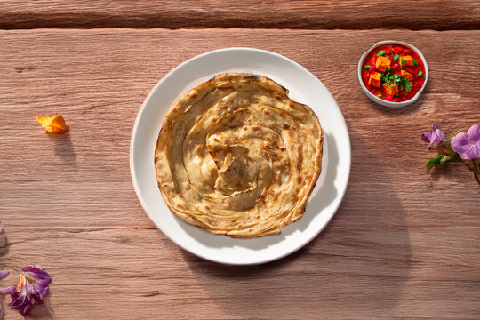 Lachha paratha or chur chur naan on a white plate