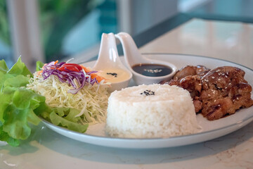 Pork neck marinated in black pepper sauce with rice, selective focus