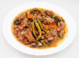Pinto beans with vegetables and meat, accompanied by gildas