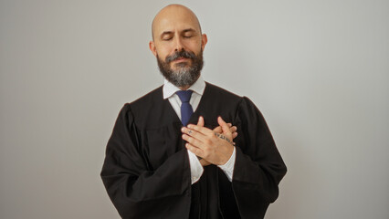 Handsome hispanic man with a beard standing with hands on heart over an isolated white background