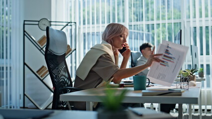Worried employee calling cellphone at workplace closeup. Upset manager talking