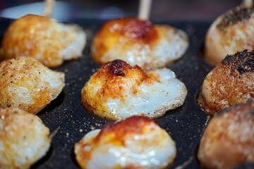 Eggs with Pepper fried in a pan. Closeup of healthy Indian street food Egg recipe prepared in a pan with holding sticks.