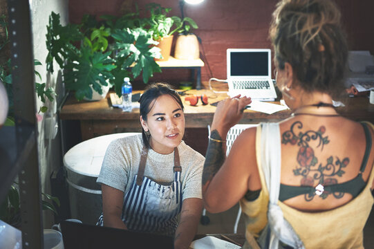 Small business, planning and women in meeting, teamwork and ideas for sales in pottery shop at laptop. Discussion, entrepreneur and people in collaboration for store, online and artisan with startup