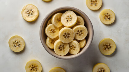 Fototapeta premium Sliced Banana in Bowl: A close-up shot captures the natural beauty and simplicity of a bowl filled with freshly sliced bananas, surrounded by scattered pieces.