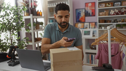 Young man scanning package with phone in home decor store surrounded by indoor plants and shelves