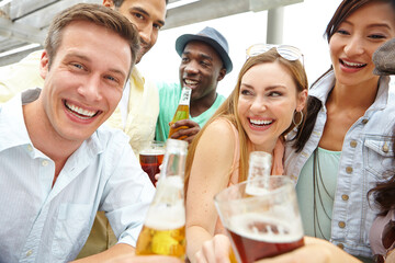 Beer, cheers and people together for celebration, milestone or social gathering in outdoor pub. Alcohol, glass and toast with group of friends with beverage in bar for party or bonding with portrait