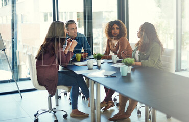 Boardroom, negotiation and people with documents, talking and collaboration for ideas in advertising agency. Planning, team and group with budget for campaign, media strategist or paperwork in office