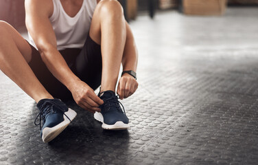 Feet, gym and shoelaces for training on floor with start, routine and sneakers for fitness in...