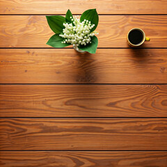 Green leaves on wooden table surface with natural texture pattern and black coffee