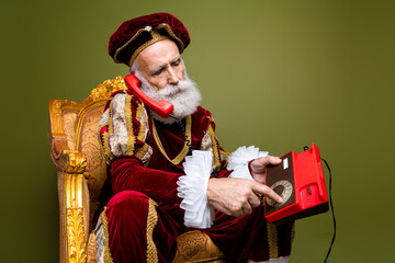 Elderly aristocrat in period attire using a rotary phone, combining historic appeal and modern...
