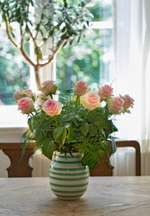 Bouquet, roses and table for decoration at house as valentines day gift, present and anniversary. Sustainable, flowers arrangement and catering for special event, romantic gesture and interior design