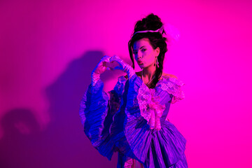 Elegant woman in historical costume posing in neon lights with dramatic expressions
