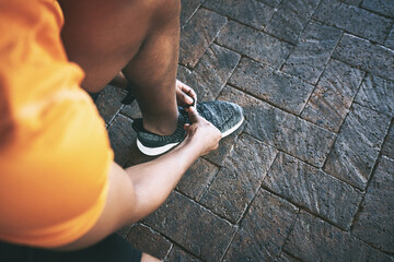 Fitness, shoes and laces with hands of man in city for workout challenge, exercise and running....