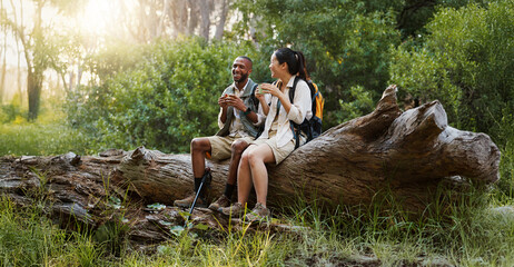Relax, coffee and hiking with interracial couple in nature for travel break, trekking adventure and park conservation. Talking, conversation and environment with man and women in forest for peace