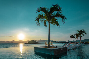 Sunrise tropical island with palm trees