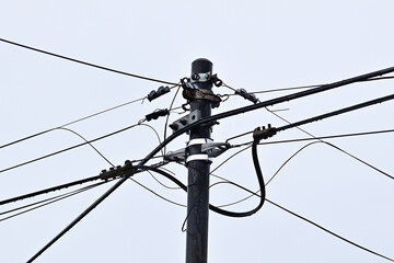 Electricity runs through power lines on a power pole
