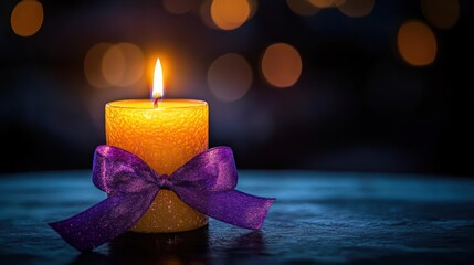Lit candle with purple ribbon on a dark background
