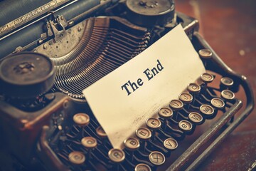 Antique typewriter with note reading "The End"