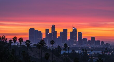 Fototapeta premium Cityscape of Los Angeles at sunset, Downtown LA skyline silhouette, Palm trees in foreground, Vibrant orange and pink sky, Urban landscape, Dramatic dusk lighting, City lights beginning to twinkle, Ic