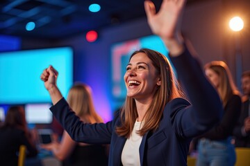 Excited Young Woman Celebrating in a Vibrant Conference Setting, Engaged in an Interactive Session with Peers in the Background and Colorful Lighting