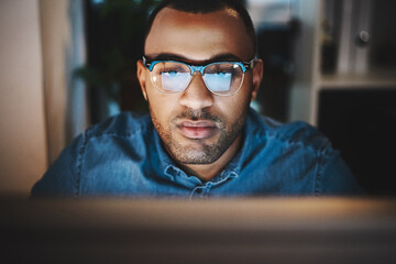 Business, man and glasses by computer at night for article draft deadline, online research or story...